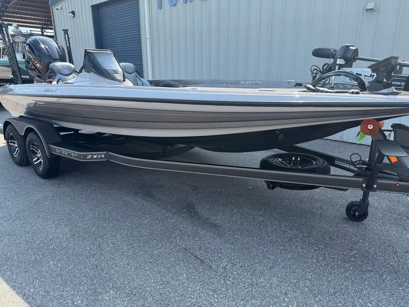 Slide: The Image of 2025 Skeeter ZXR20 boat on trailer, parked outdoors, showcasing sleek design and modern features. - 2
