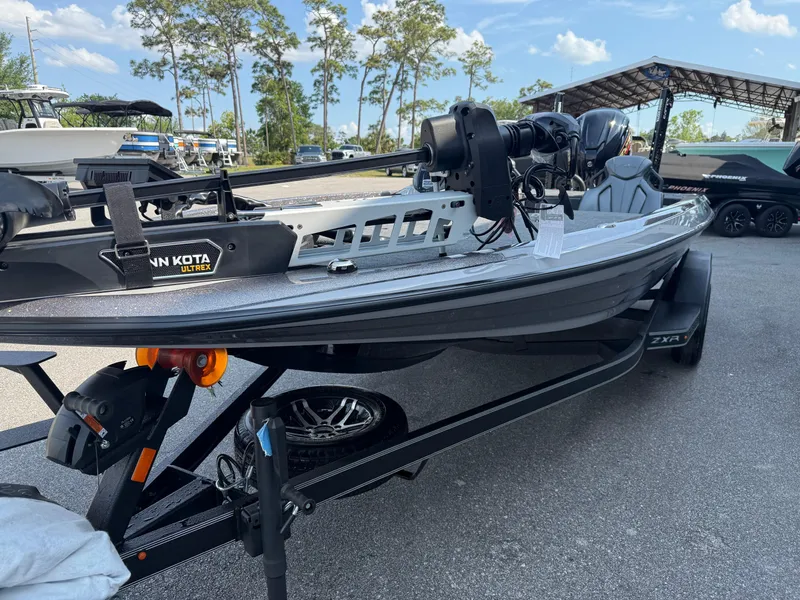 Slide: The Image of 2025 Skeeter ZXR20 boat on trailer, featuring Minn Kota trolling motor, parked outdoors. - 3