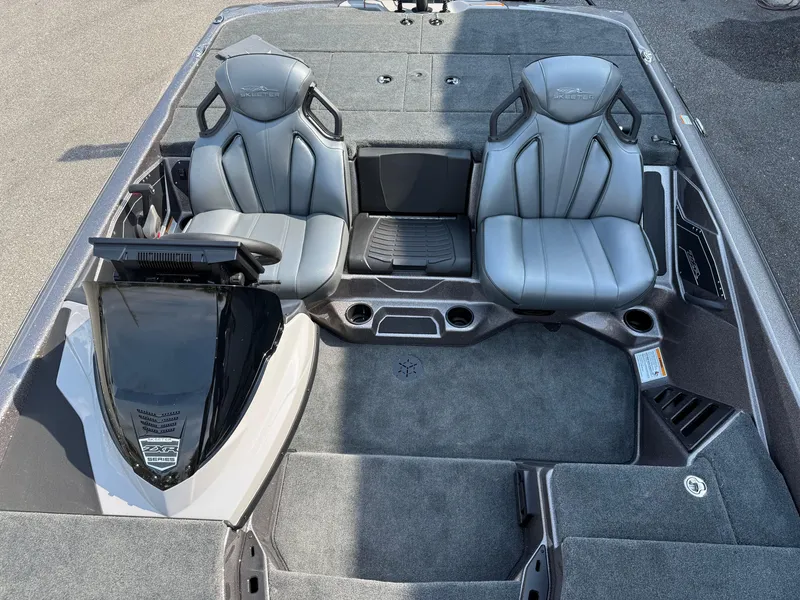Slide: The Image of 2025 Skeeter ZXR20 boat interior with two gray seats and carpeted flooring. - 6