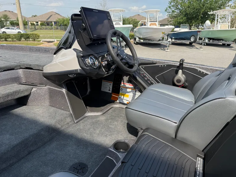 Slide: The Image of 2025 Skeeter ZXR20 boat interior with steering wheel and dashboard controls. - 7