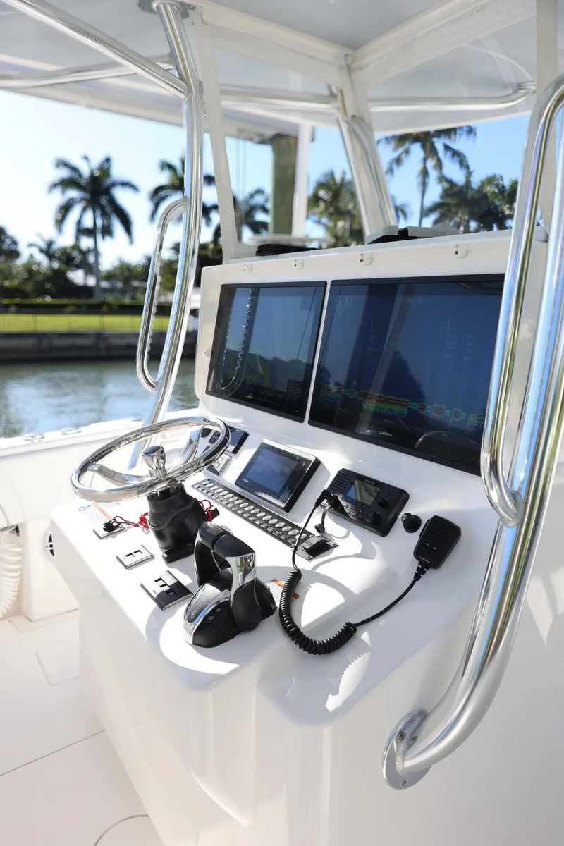 Slide: The Image of 2022 Contender 39 ST boat cockpit with advanced navigation systems and controls. - 10