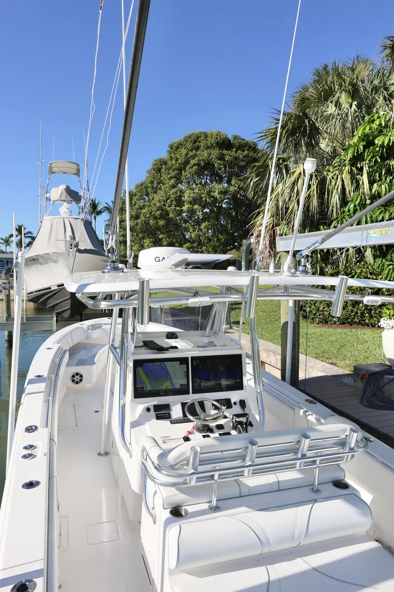 Slide: The Image of 2022 Contender 39 ST boat docked, featuring sleek design and advanced navigation systems. - 13