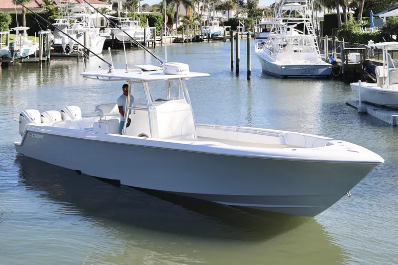 Slide: The Image of 2022 Contender 39 ST boat cruising in a marina with multiple outboard engines. - 8