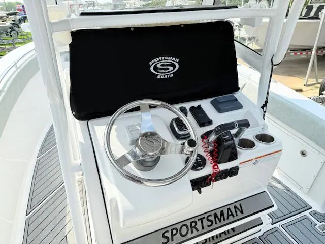 Slide: The Image of 2019 Sportsman Open 282TE Center Console boat dashboard with steering wheel and controls. - 11
