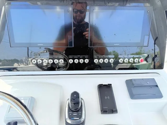 Slide: The Image of 2019 Sportsman Open 282TE Center Console dashboard with dual screens and controls. - 13