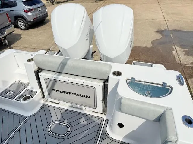 Slide: The Image of 2019 Sportsman Open 282TE Center Console boat with dual engines and seating area. - 16