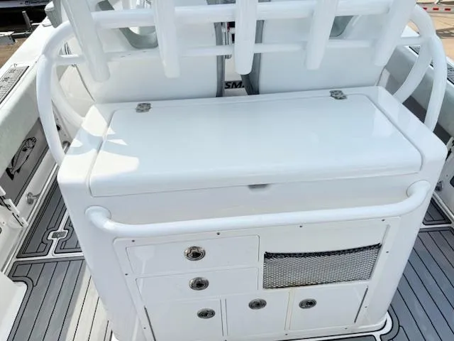 Slide: The Image of 2019 Sportsman Open 282TE Center Console boat interior with storage compartments. - 17