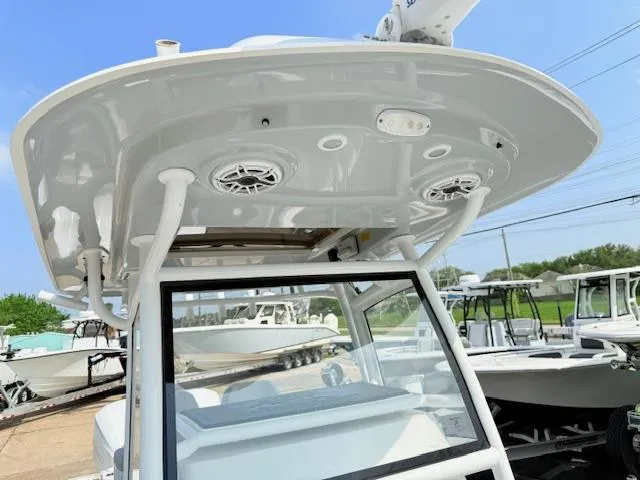 Slide: The Image of 2019 Sportsman Open 282TE Center Console boat with speakers and canopy. - 2