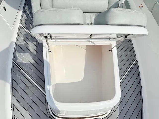 Slide: The Image of 2019 Sportsman Open 282TE Center Console boat with open storage compartment and cushioned seating. - 6