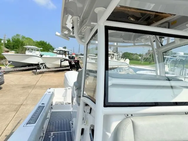 Slide: The Image of 2019 Sportsman Open 282TE Center Console boat at a marina, showcasing sleek design and features. - 8