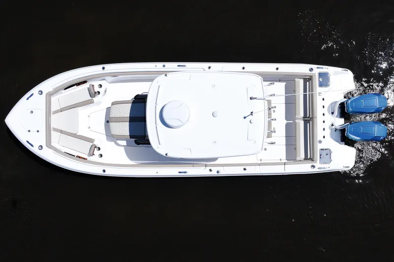 Slide: The Image of 2024 Everglades 315CC boat, aerial view, twin engines, sleek design, spacious deck. - 19