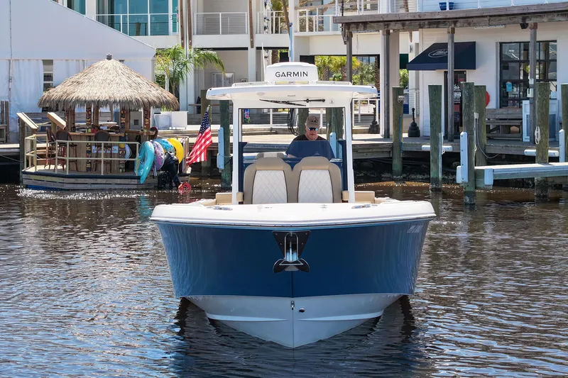 Slide: The Image of 2024 Everglades 315CC boat docked in marina, featuring Garmin equipment. - 27