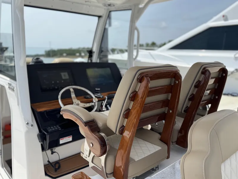 Slide: The Image of 2024 Everglades 315CC boat interior with luxurious seating and modern dashboard. - 31