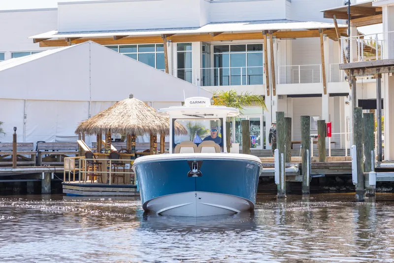 Slide: The Image of 2024 Everglades 315CC boat docked near waterfront buildings. - 4
