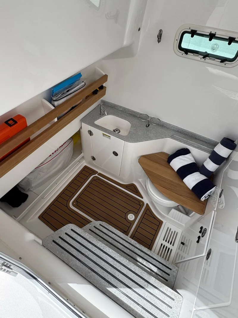 Slide: The Image of 2024 Everglades 315CC cabin interior with wooden flooring and compact amenities. - 41