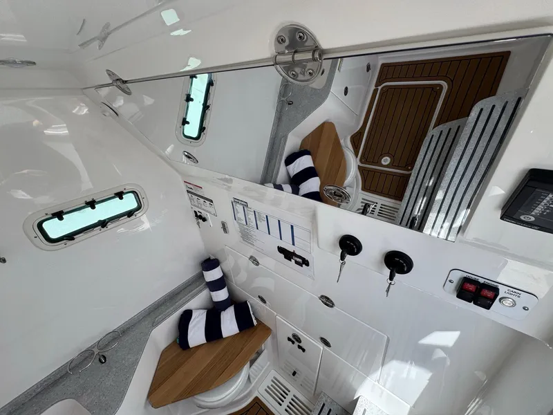 Slide: The Image of 2024 Everglades 315CC boat interior with modern amenities and nautical decor. - 42