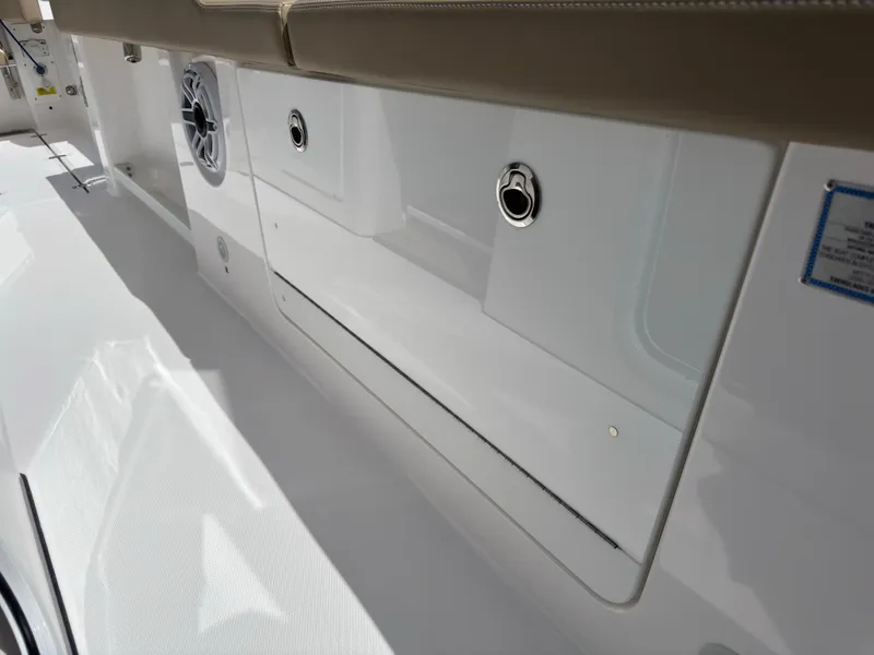 Slide: The Image of 2024 Everglades 315CC boat interior with sleek white paneling and speaker system. - 47