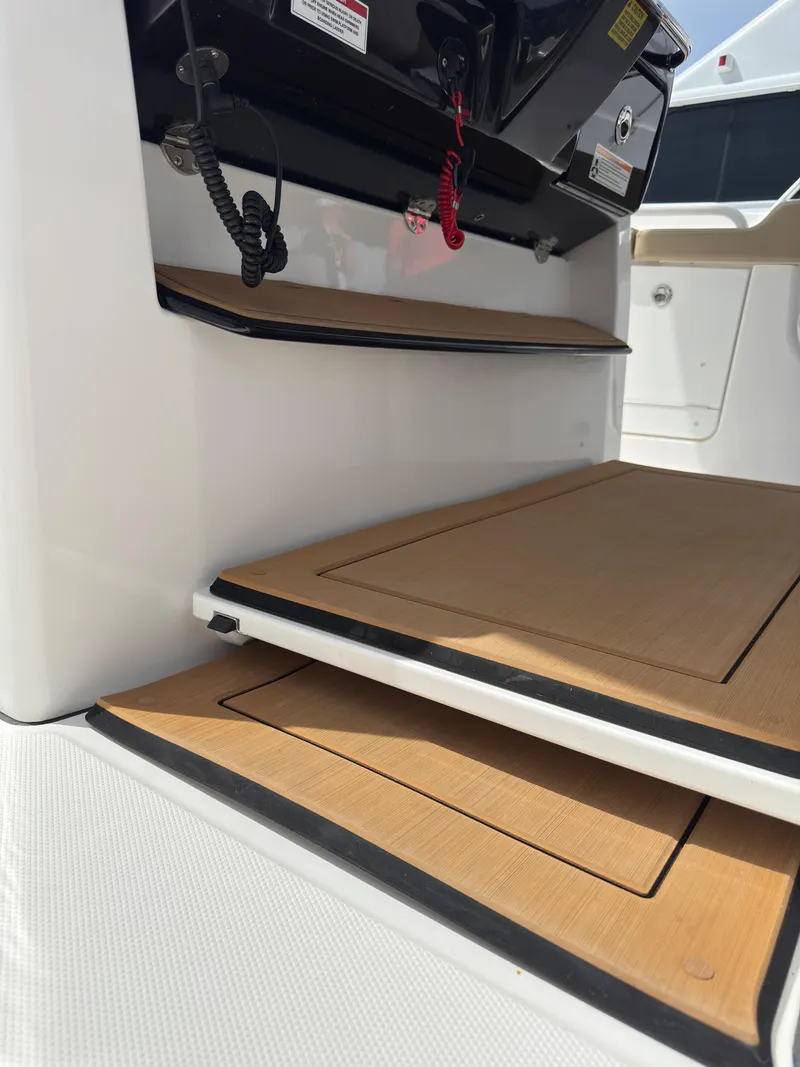 Slide: The Image of 2024 Everglades 315CC boat deck with wood finish and control panel. - 48
