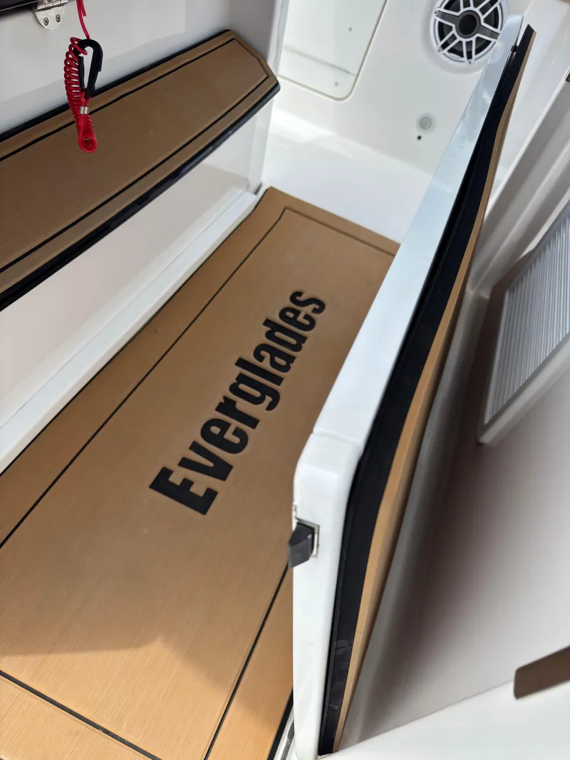 Slide: The Image of 2024 Everglades 315CC boat interior with branded flooring and seating. - 49