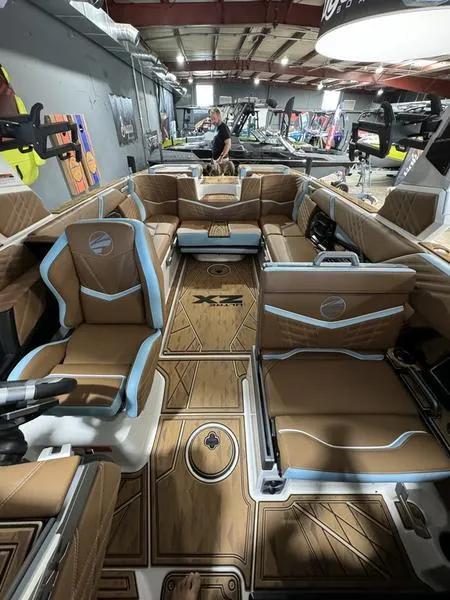 Slide: The Image of 2024 Tigé Ultré 25ZX boat interior with luxurious seating and modern design. - 2