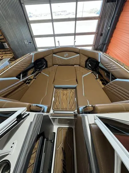 Slide: The Image of 2024 Tigé Ultré 25ZX boat interior with luxurious brown seating and modern design. - 4