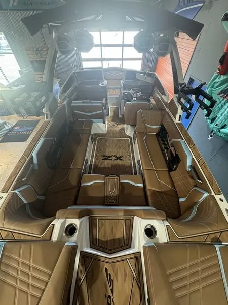 Slide: The Image of 2024 Tigé Ultré 25ZX boat interior with luxurious brown seating and modern design. - 5
