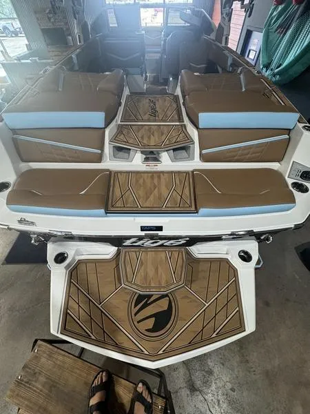 Slide: The Image of 2024 Tigé Ultré 25ZX boat interior with brown and blue seating. - 6