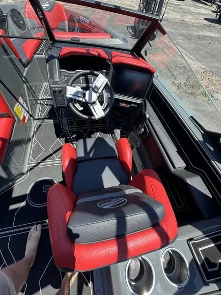 Slide: The Image of 2024 Tigé Z5 boat interior with red and black seating, modern dashboard, and steering wheel. - 3