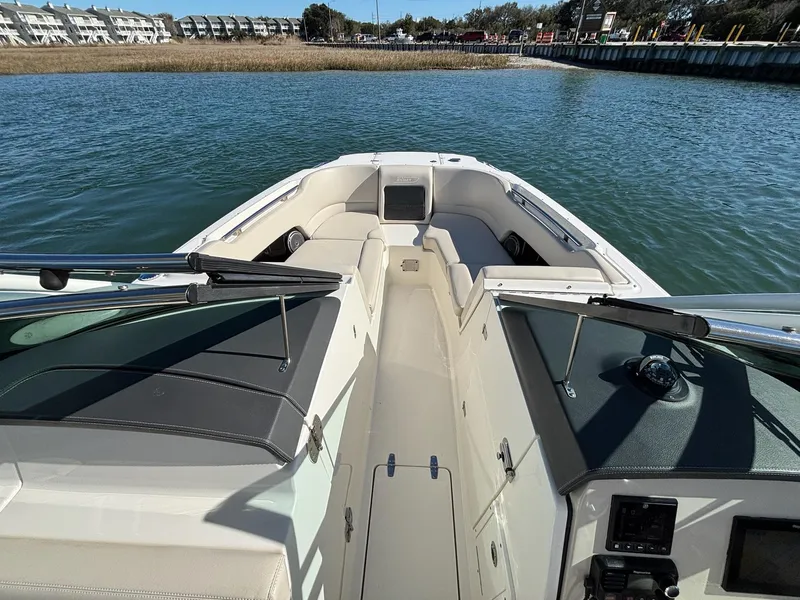 Slide: The Image of 2018 Boston Whaler 230 Vantage boat interior with seating, on calm water. - 14