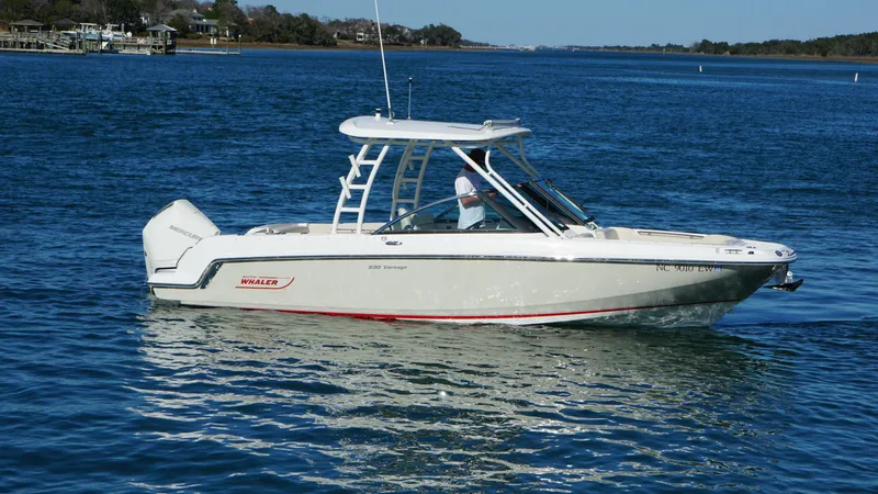 Slide: The Image of 2018 Boston Whaler 230 Vantage boat cruising on a calm blue lake. - 3