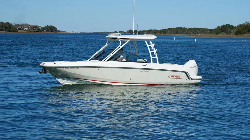 Slide: The Image of 2018 Boston Whaler 230 Vantage boat cruising on a calm blue lake. - 8
