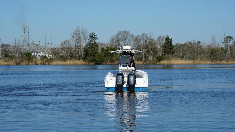 Slide: The Image of 2015 Contender 25 Tournament boat on calm water with dual engines. - 29
