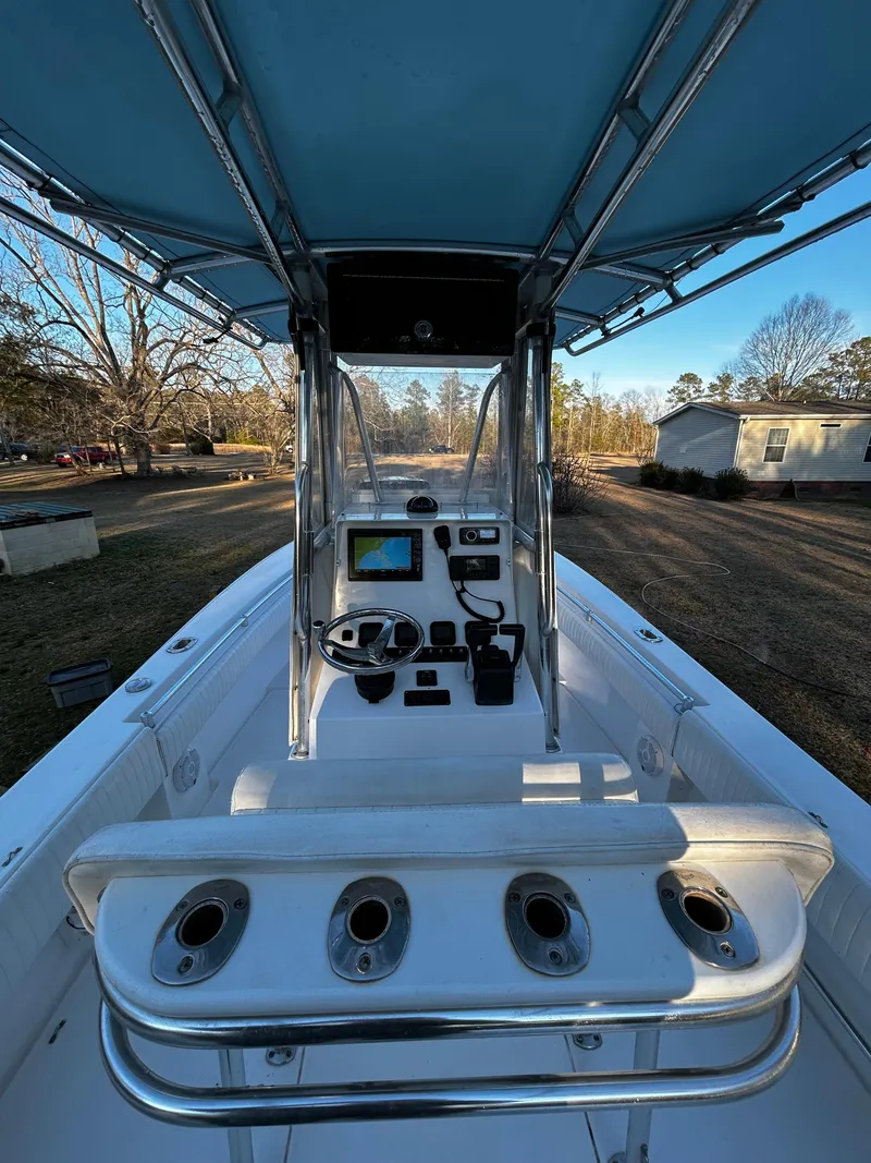 Slide: The Image of 2015 Contender 25 Tournament boat interior with console and seating, under blue canopy. - 31