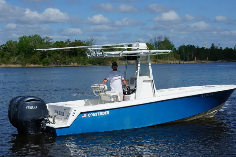 Slide: The Image of 2015 Contender 25 Tournament boat with Yamaha engine on a calm lake. - 39