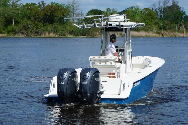 Slide: The Image of 2015 Contender 25 Tournament boat with dual Yamaha 150 engines on a calm lake. - 40