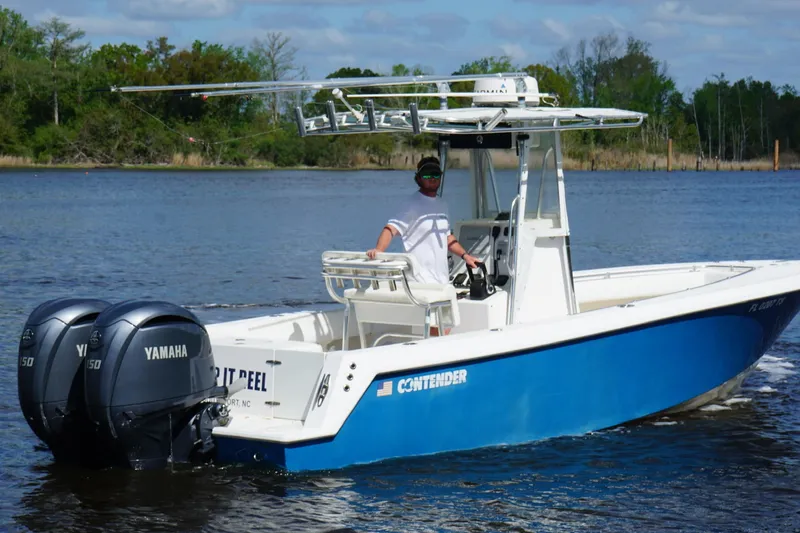 Slide: The Image of 2015 Contender 25 Tournament boat with dual Yamaha engines on a calm lake. - 41