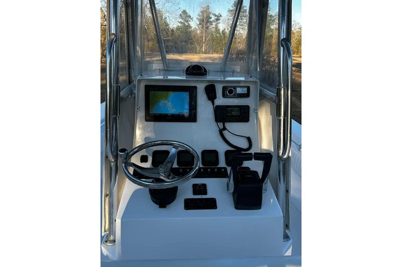 Slide: The Image of 2015 Contender 25 Tournament boat console with steering wheel and navigation equipment. - 47