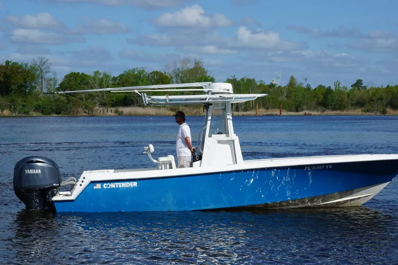 Slide: The Image of 2015 Contender 25 Tournament boat with Yamaha engine on a calm lake. - 50