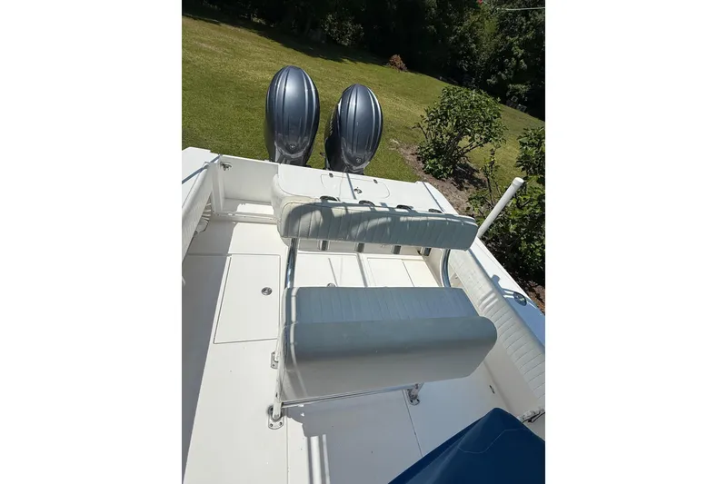 Slide: The Image of 2015 Contender 25 Tournament boat with dual engines and seating, on grassy background. - 52