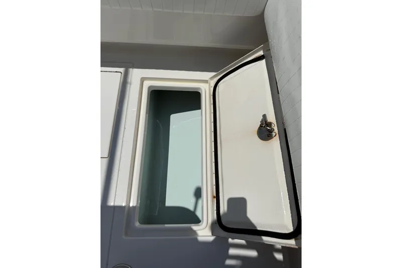 Slide: The Image of Open storage compartment on a 2015 Contender 25 Tournament boat. - 54