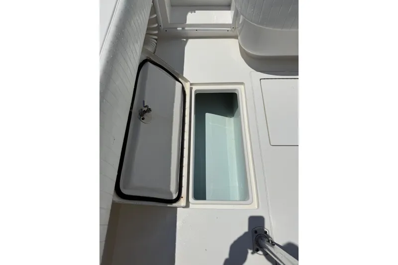 Slide: The Image of Open storage compartment on a 2015 Contender 25 Tournament boat deck. - 55