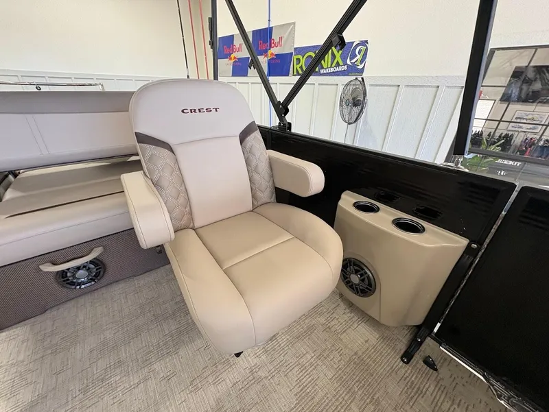 Slide: The Image of 2025 Crest Classic 220 boat interior with beige seating and cup holders. - 10