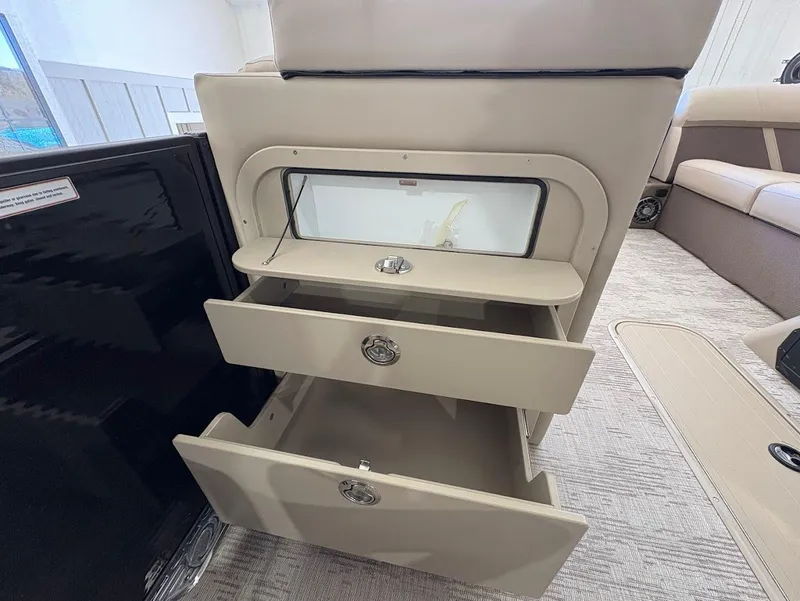 Slide: The Image of 2025 Crest Classic 220 boat interior with beige seating and cup holders. - 11