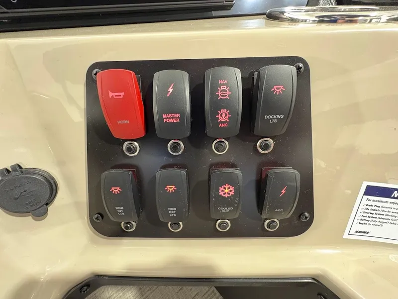 Slide: The Image of 2025 Crest Classic 220 with Mercury outboard engine in a garage setting. - 13