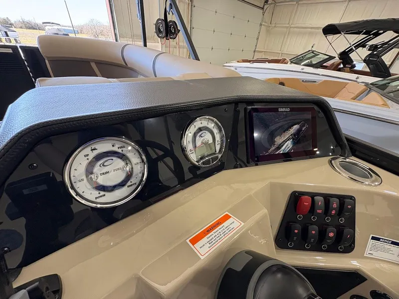 Slide: The Image of Interior of 2025 Crest Classic 220 boat with beige seating and modern controls. - 14