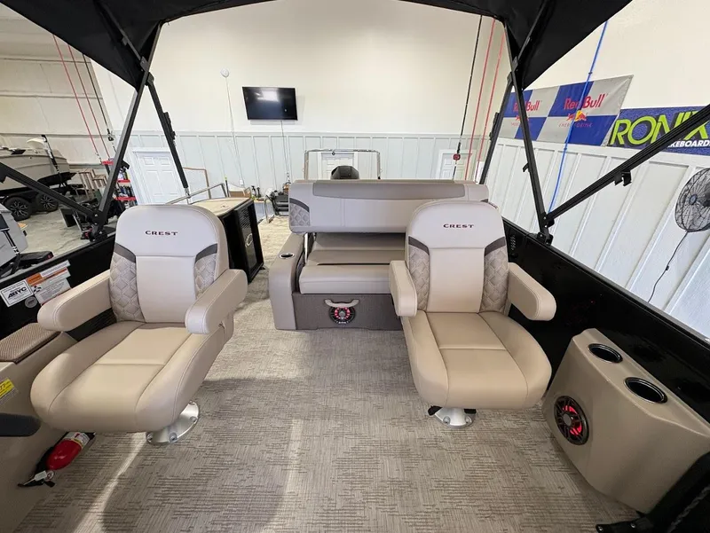 Slide: The Image of Luxurious seating in 2025 Crest Classic 220 boat, featuring beige upholstery and integrated speaker. - 17