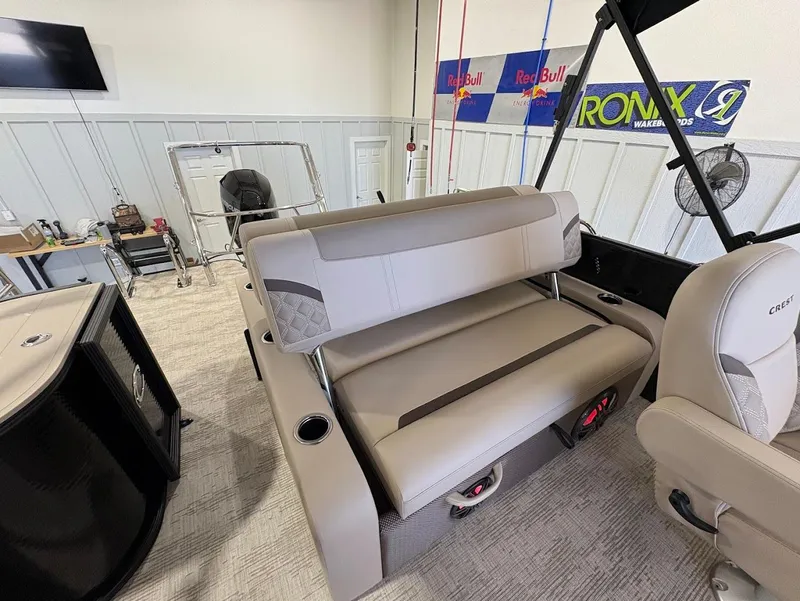 Slide: The Image of 2025 Crest Classic 220 boat interior with beige and brown seating, quilted design. - 18