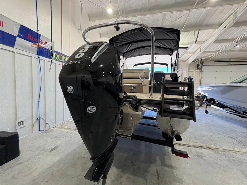 Slide: The Image of 2025 Crest Classic 220 pontoon boat on trailer in showroom. - 2