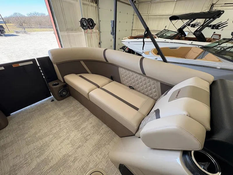 Slide: The Image of 2025 Crest Classic 220 pontoon boat in showroom, rear view with motor and ladder. - 7