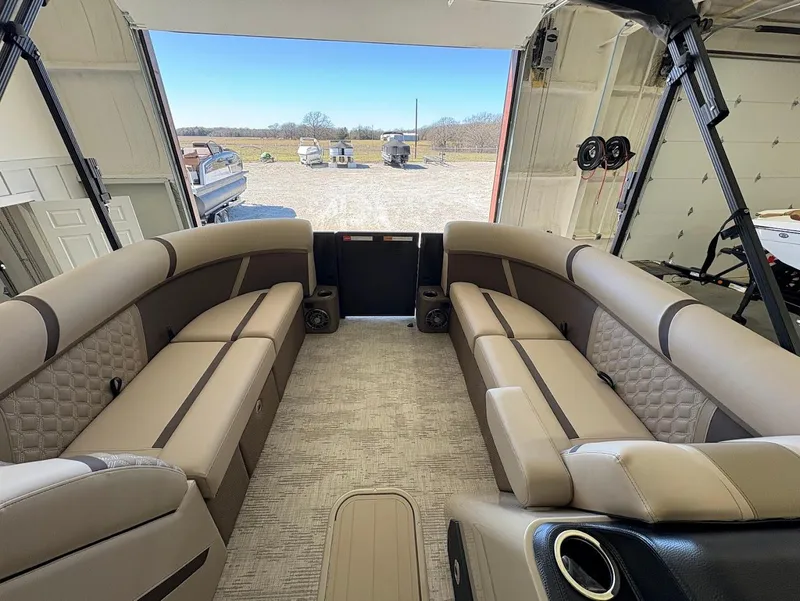 Slide: The Image of 2025 Crest Classic 220 pontoon boat with Mercury engine on trailer in showroom. - 8